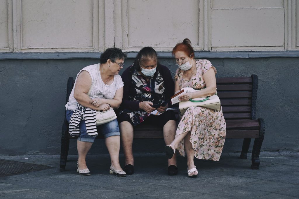 3 women sitting on bench