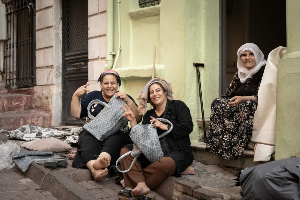 A group of women sitting on the steps of a building